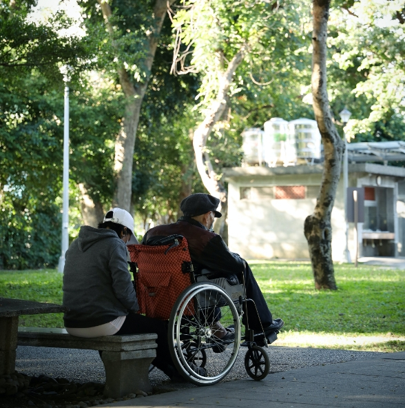 an old man sitting on the wheelchair